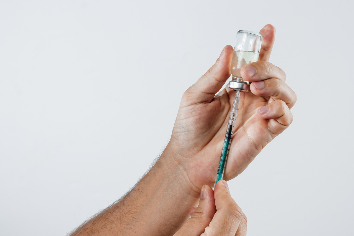 close-up in a man's hand ampoule with medication and syringe for insulin. The concept of taking medication, treatment, put an injection.